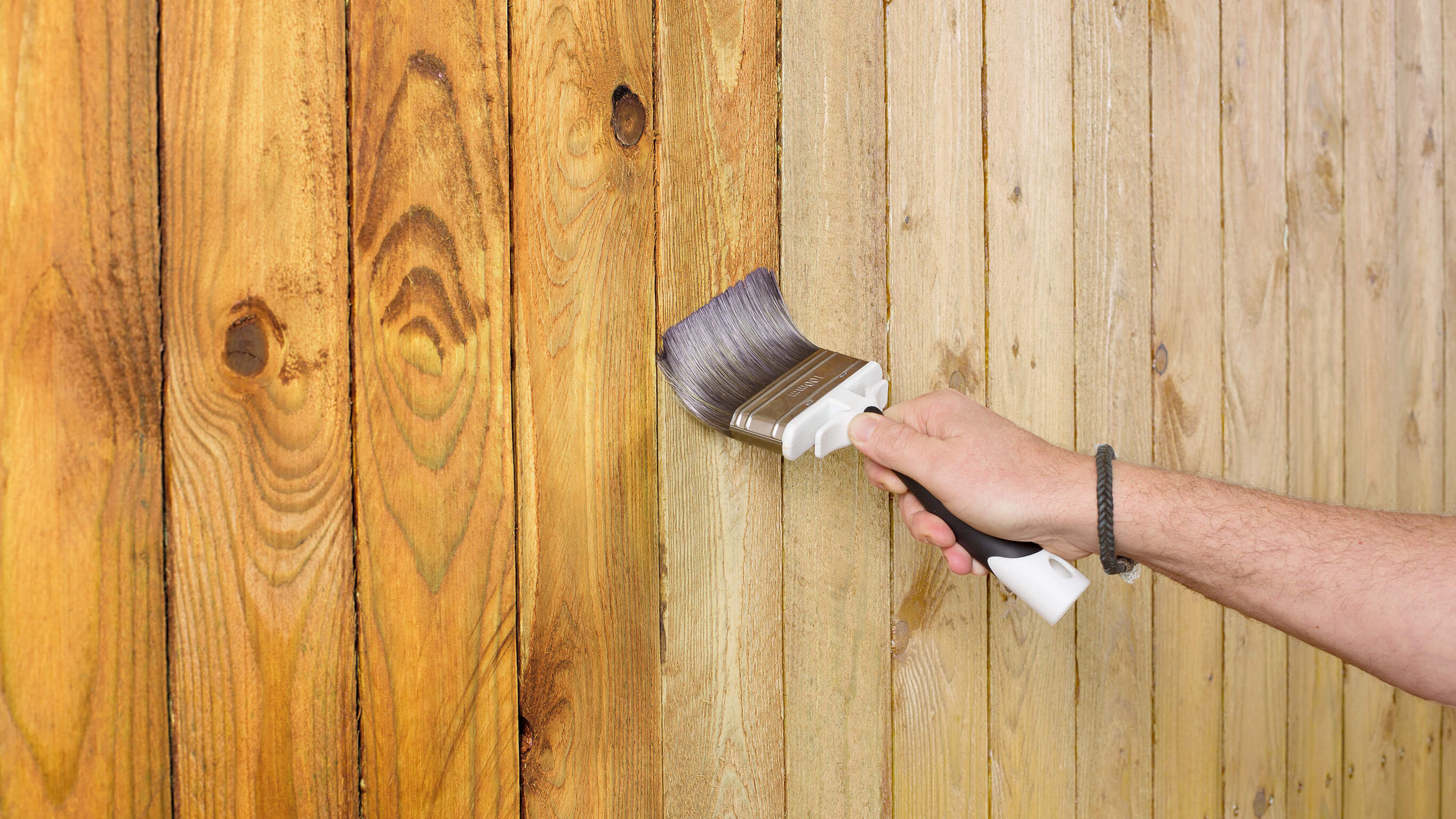 Varnishing a fence Varnishing a wooden fence