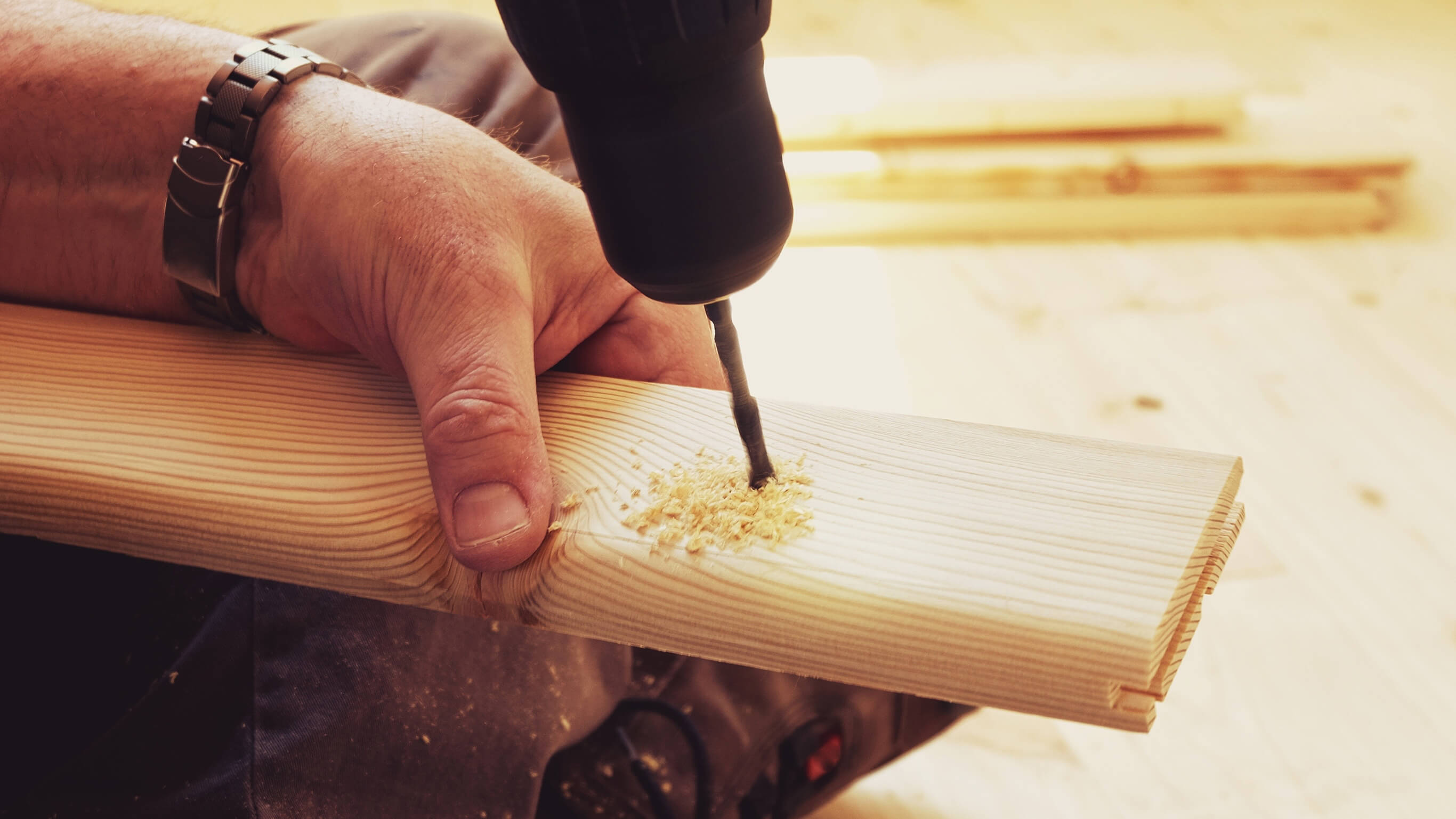 Drilling wood Person drilling plank of wood
